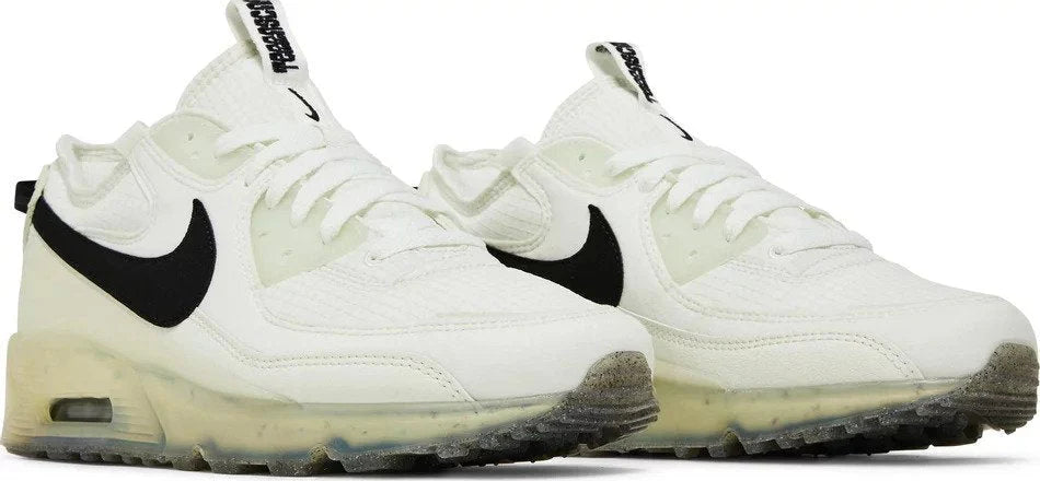 White sneakers with black swoosh logo on a white background